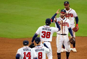 ATLANTA, GEORGIA - OCTOBER 30: Guillermo Heredia #38 and Dansby Swanson #7 of the Atlanta Braves celebrates the team's 3-2 win against the Houston Astros in Game Four of the World Series at Truist Park on October 30, 2021 in Atlanta, Georgia. Todd Kirklan